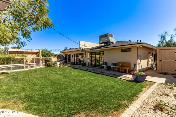 a view of a house with backyard sitting area and garden