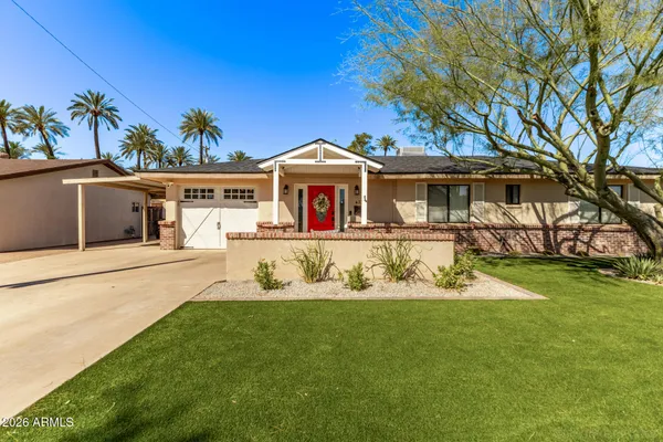 a front view of a house with a yard table and chairs