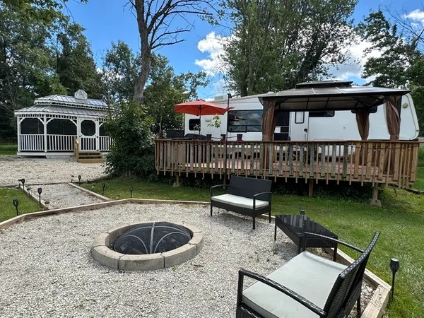 a view of a house with backyard and sitting area