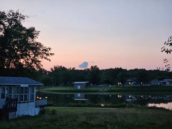 a view of a lake with houses in the back