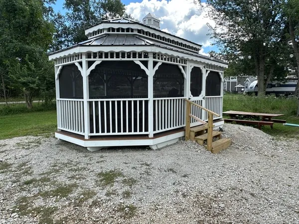 a view of a house with backyard and a garden