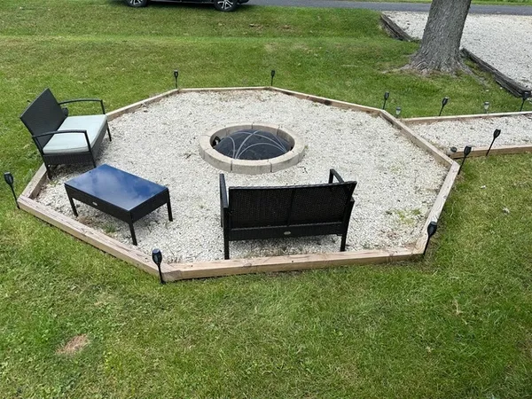 a view of a backyard with sitting area