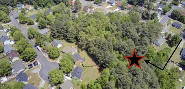 an aerial view of a house with a yard and outdoor seating