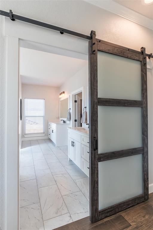 107 Kleingrass Road Abilene, TX 79606 - Photo 12 of 33 Barn door entry featuring a dark wood frame and frosted glass panels