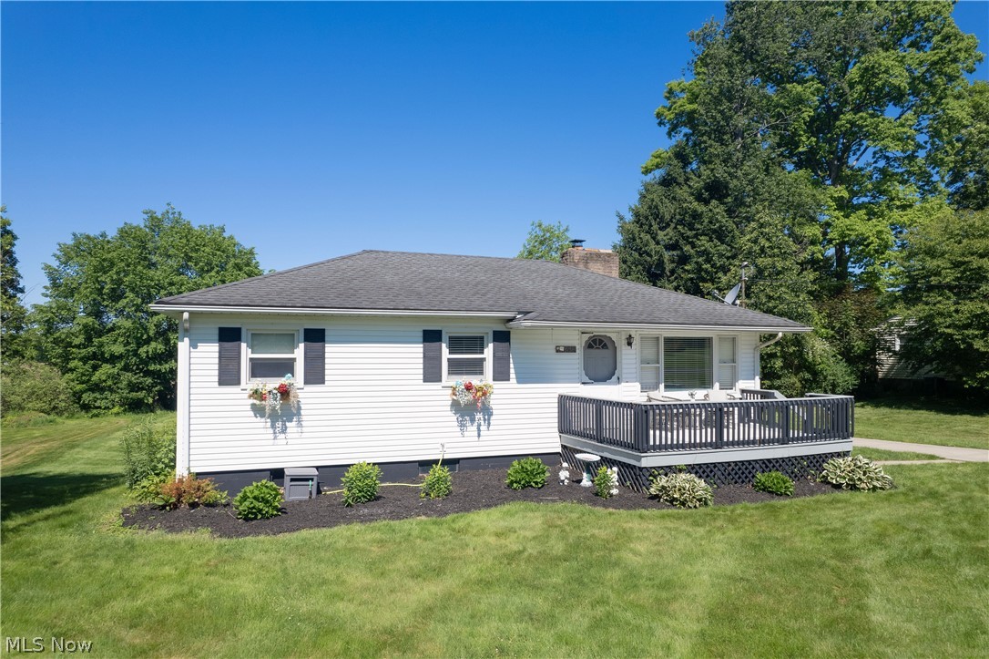 3659 Morrow Road Kent, OH 44240 - Photo 3 of 39 White vinyl siding exterior with dark shutters, a dark shingle roof, and a front deck with dark railings