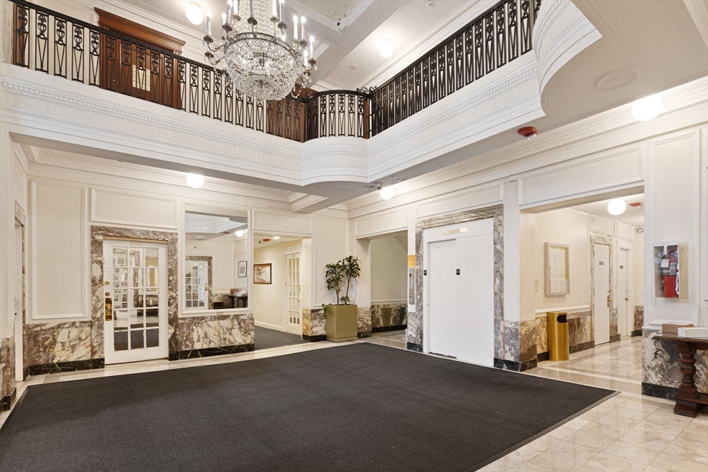 466 Commonwealth Avenue, Unit 502 Boston, MA 02215 - Photo 3 of 16 a view of a hallway with a chandelier