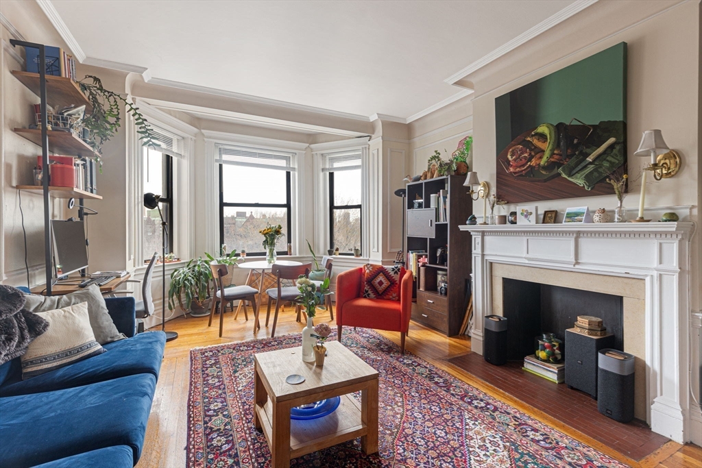 466 Commonwealth Avenue, Unit 502 Boston, MA 02215 - Photo 5 of 16 a living room with furniture a fireplace and a flat screen tv