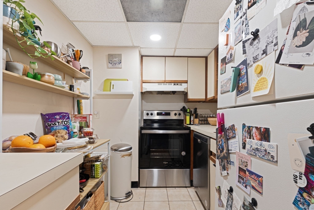 466 Commonwealth Avenue, Unit 502 Boston, MA 02215 - Photo 8 of 16 a kitchen with stainless steel appliances granite countertop a refrigerator and a stove