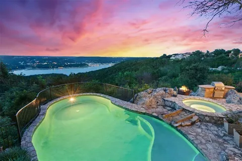 a view of a swimming pool with a patio and a garden