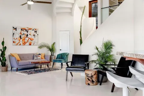 a living room with furniture and a potted plant