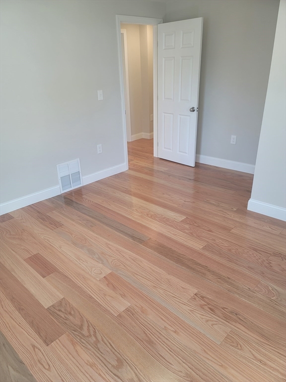 98 Uncatena Avenue, Unit L Worcester, MA 01606 - Photo 7 of 11 a view of an empty room with wooden floor