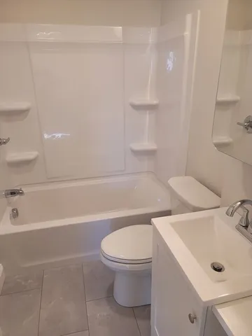 a bathroom with a toilet a sink and bathtub