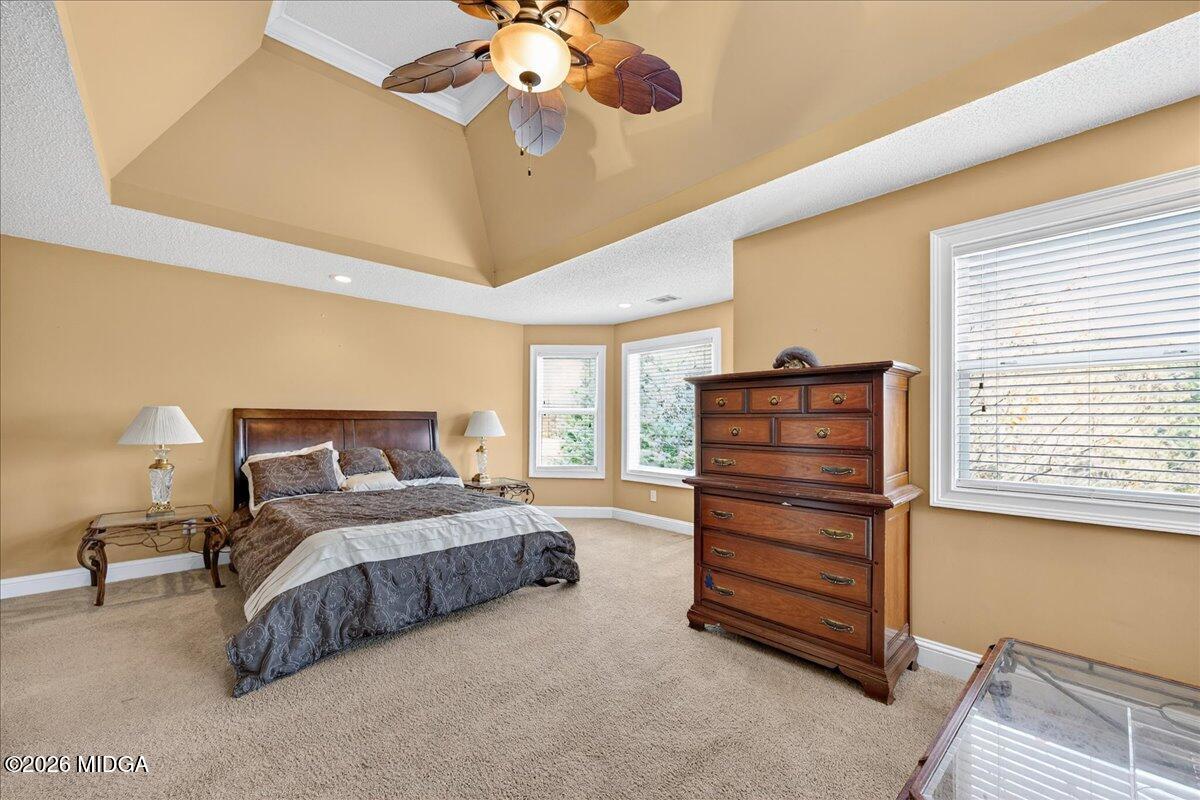 518 River Overlook Forsyth, GA 31029 - Photo 31 of 96 a bedroom with a bed and a chandelier