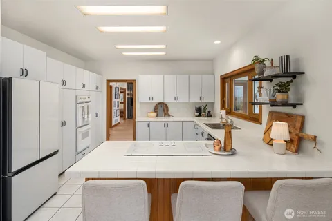 a kitchen with a refrigerator a stove and a sink