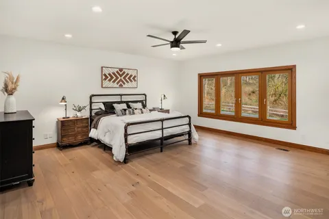 a spacious bedroom with a bed and a large window