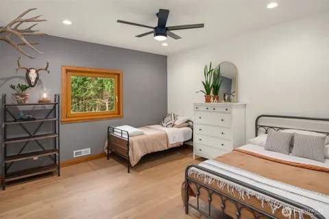 a bedroom with a bed and a dresser in it