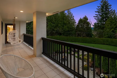 a view of balcony with two chairs and a garden