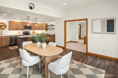 a dining room with kitchen island a dining table and chairs