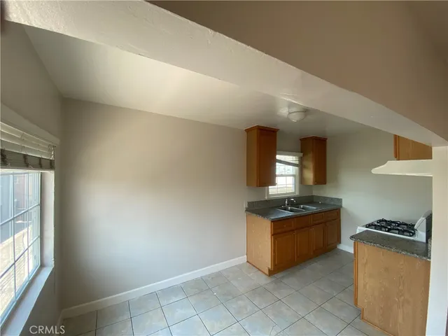 a kitchen with granite countertop a stove and a refrigerator