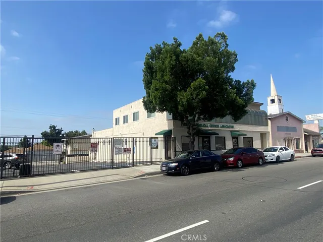 a couple of cars parked in front of a building