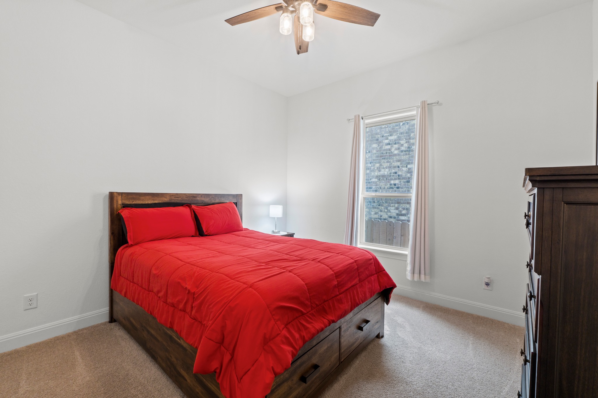 271 Tubman Drive Kyle, TX 78640 - Photo 21 of 40 a bedroom with a bed and a chandelier