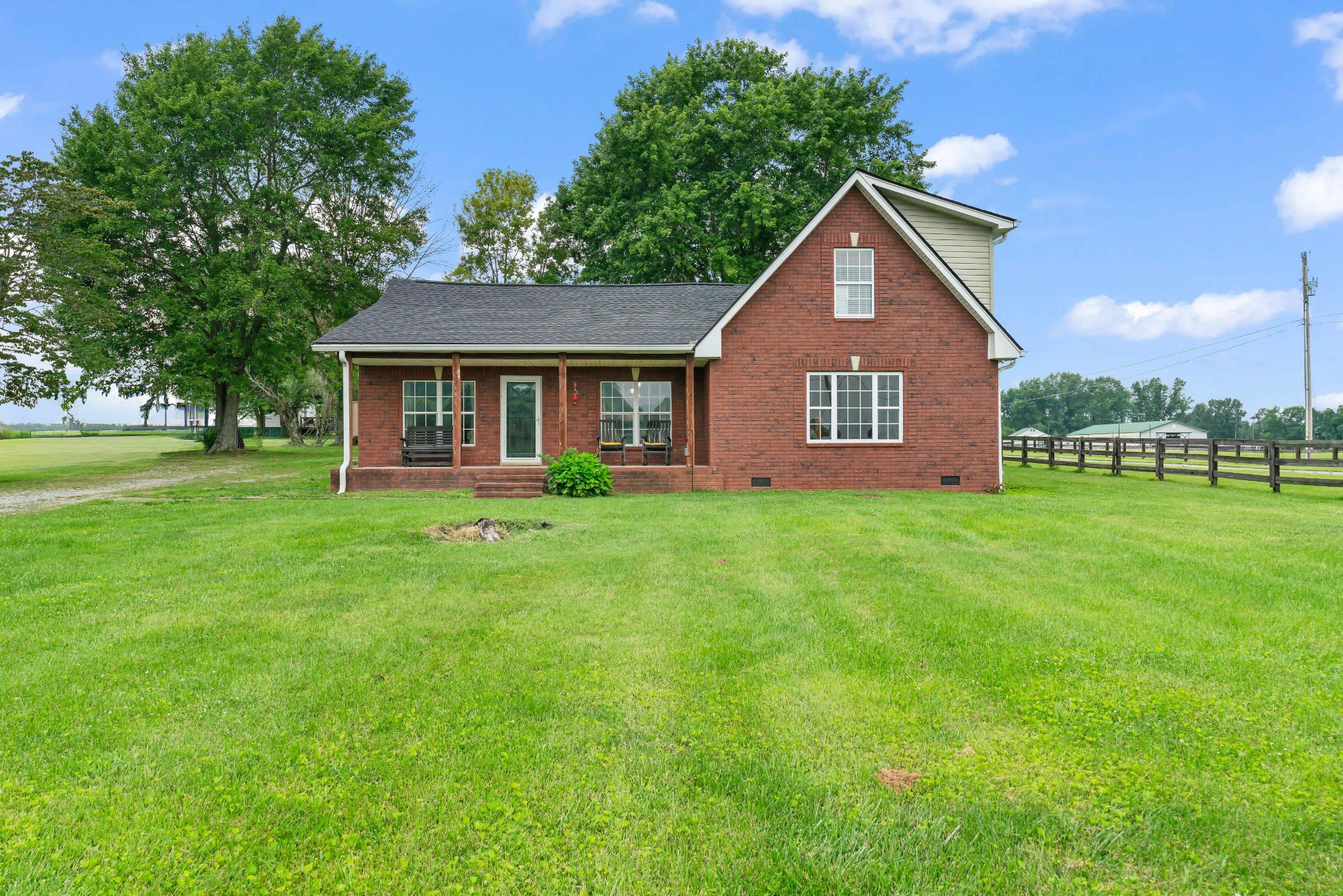 a front view of house with yard and green space
