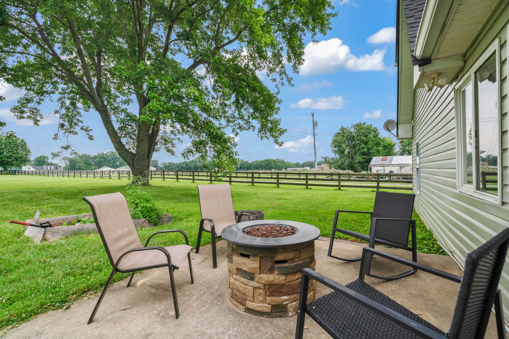 443 Halltown Road Portland, TN 37148 - Photo 12 of 49 a view of a patio with table and chairs potted plants and a palm tree