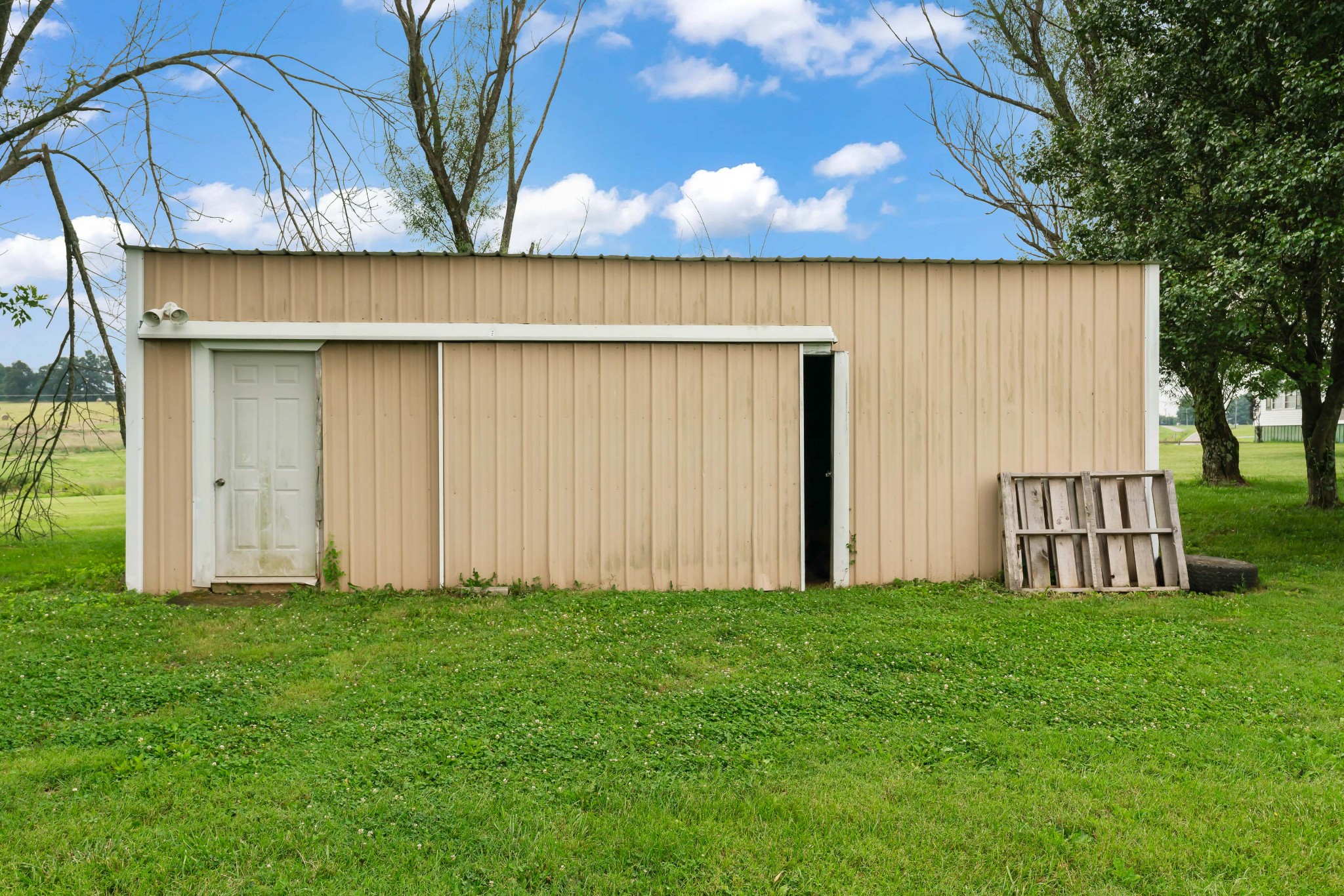 443 Halltown Road Portland, TN 37148 - Photo 15 of 49 a backyard of a house with lots of green space and trampoline