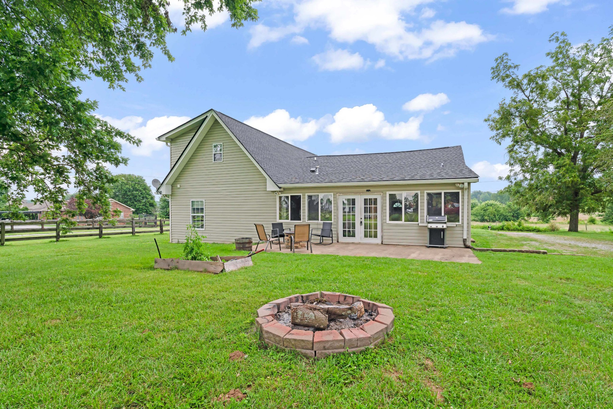 443 Halltown Road Portland, TN 37148 - Photo 9 of 49 a front view of a house with a yard garage and outdoor seating