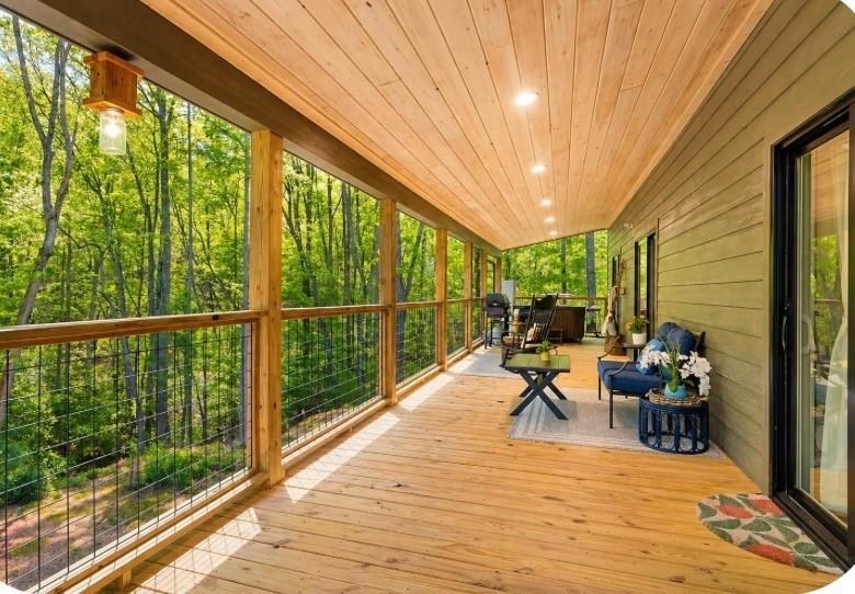 191 Oakwood Road Blairsville, GA 30512 - Photo 30 of 43 a view of a balcony with chairs and wooden floor