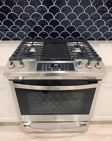 a view of a kitchen counter space a sink and dishwasher with wooden floor