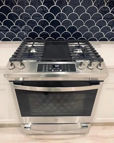 a view of a kitchen counter space a sink and dishwasher with wooden floor