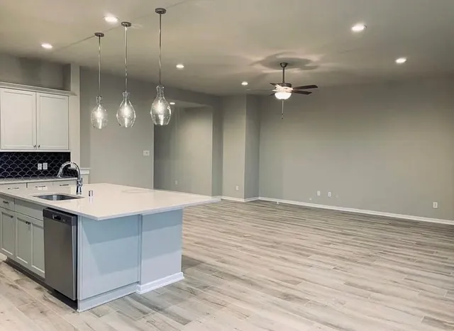 a kitchen with a sink stainless steel appliances and cabinets