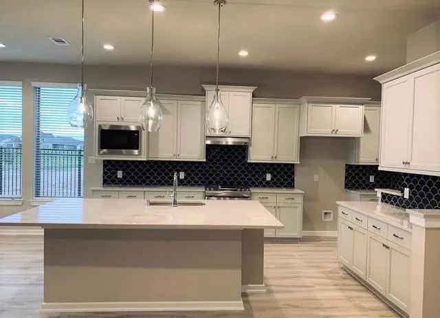 a view of kitchen with cabinets and wooden floor