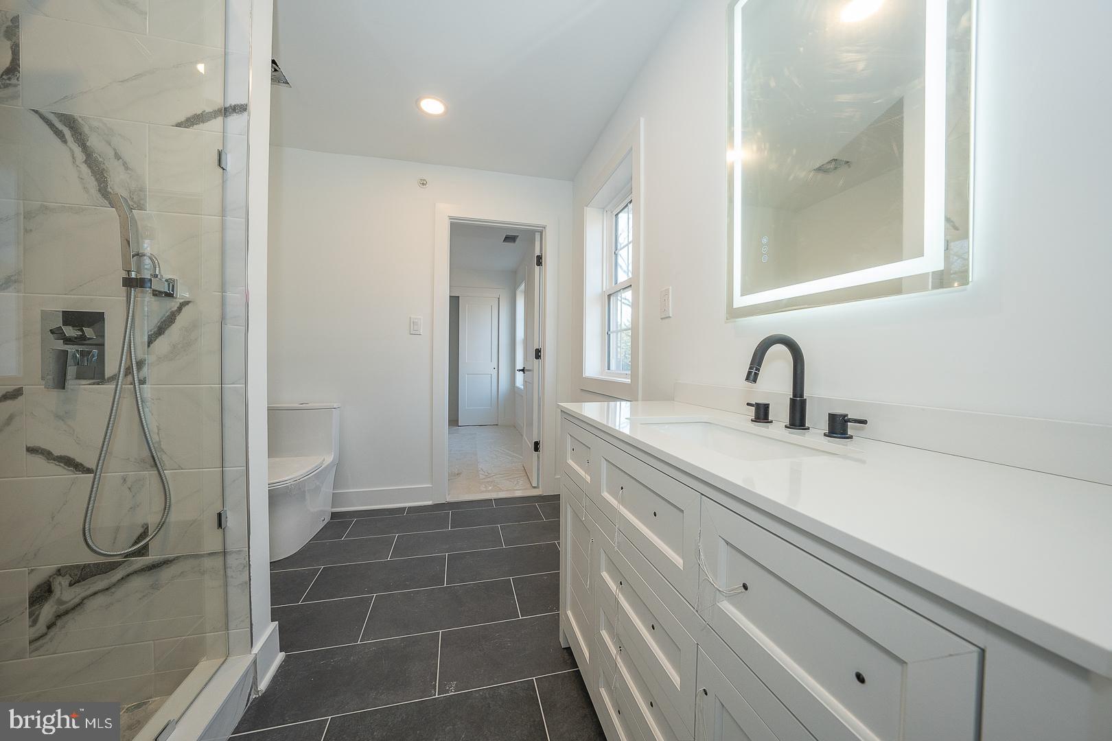 2627 County Line Road Chalfont, PA 18914 - Photo 23 of 37 a bathroom with a shower sink and mirror