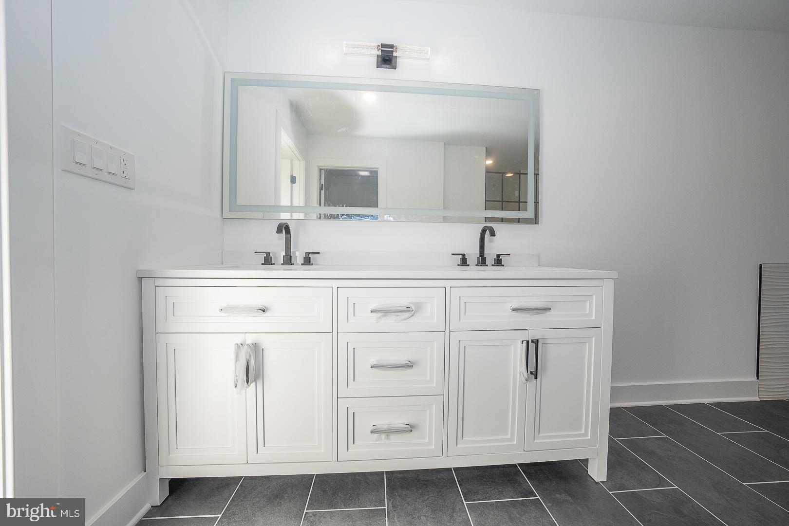 2627 County Line Road Chalfont, PA 18914 - Photo 30 of 37 a bathroom with a sink vanity and mirror