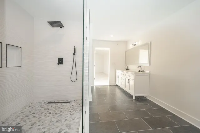 a bathroom with a shower and a sink