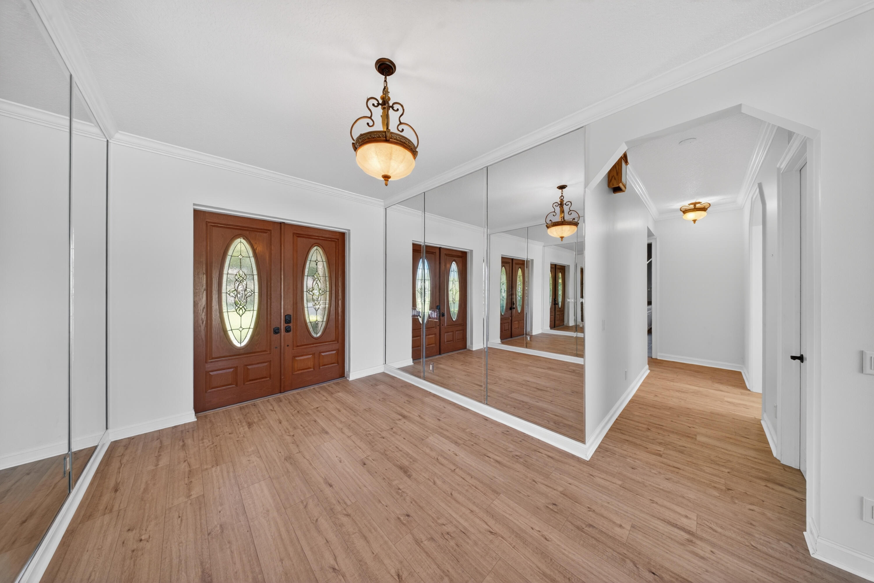 8686 Andrews Avenue Fort Pierce, FL 34945 - Photo 14 of 76 a view of an empty room with window and wooden floor