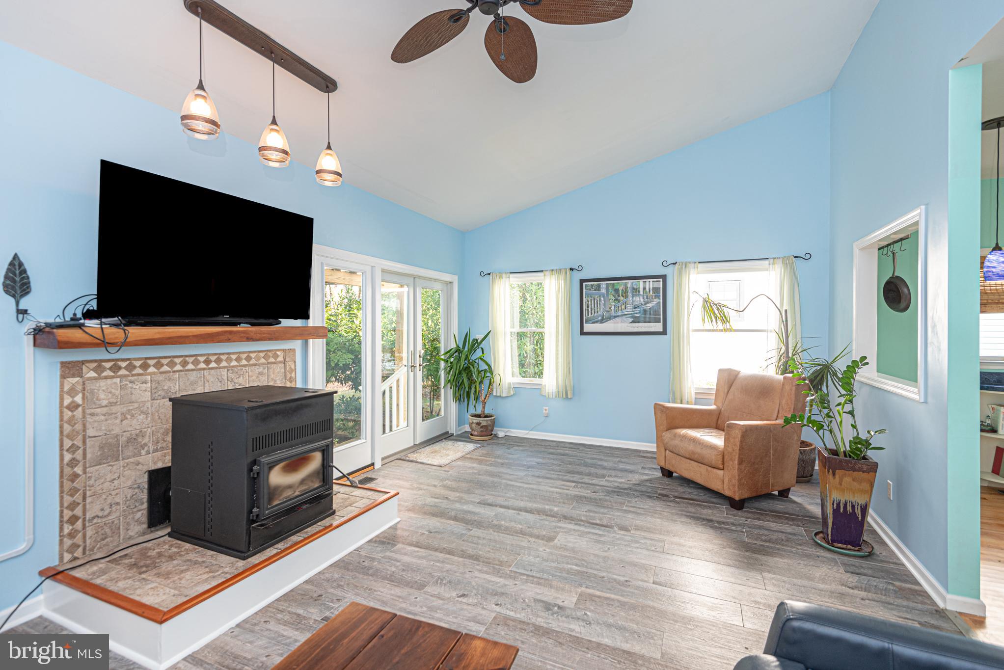 263 Oyster Shell Cove Bethany Beach, DE 19930 - Photo 15 of 50 a living room with furniture a flat screen tv and a fireplace
