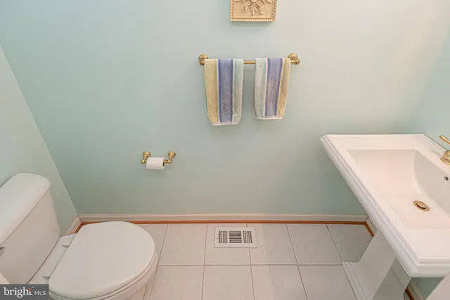 a white toilet sitting next to a shower