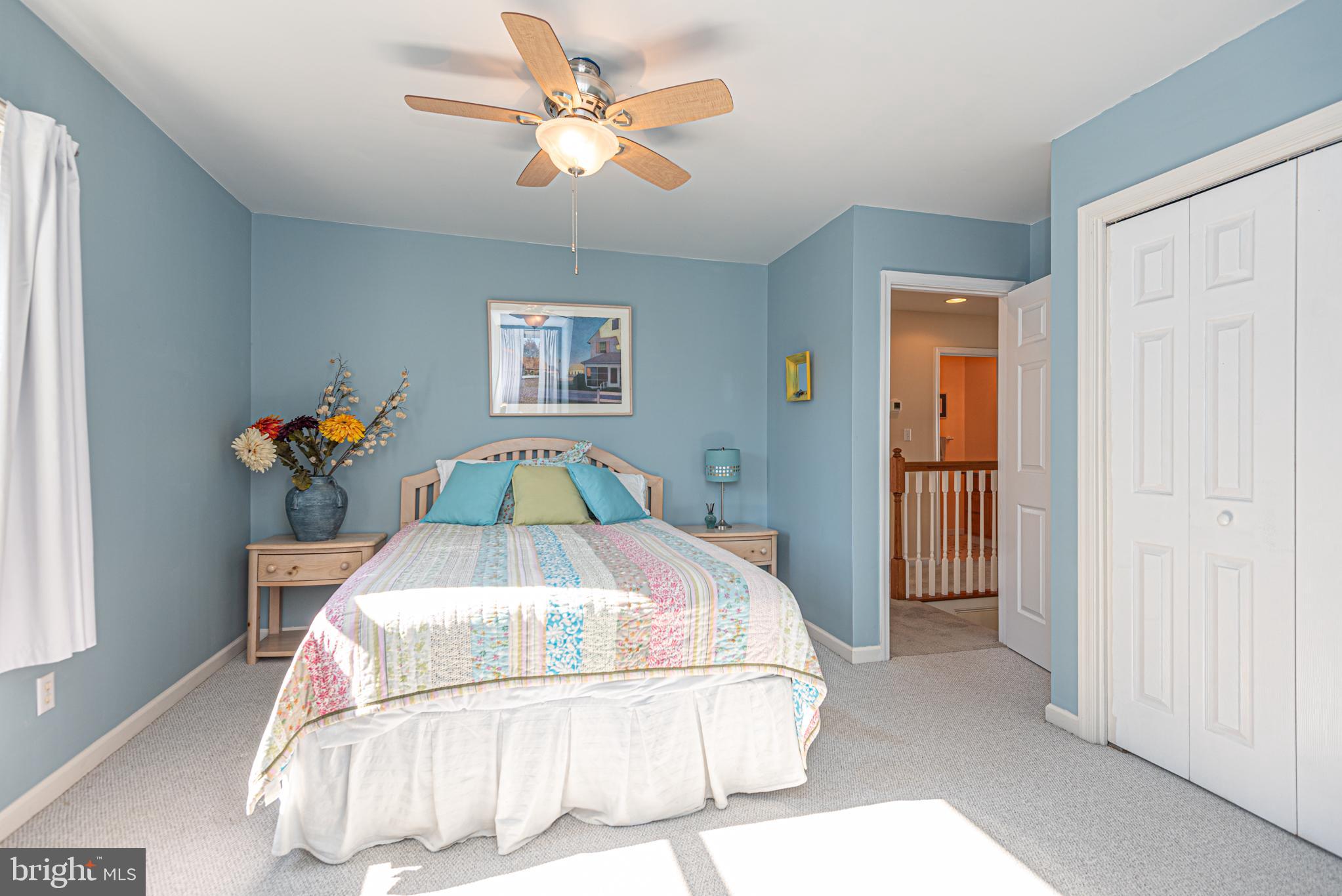 263 Oyster Shell Cove Bethany Beach, DE 19930 - Photo 23 of 50 a bedroom with a bed and a chandelier