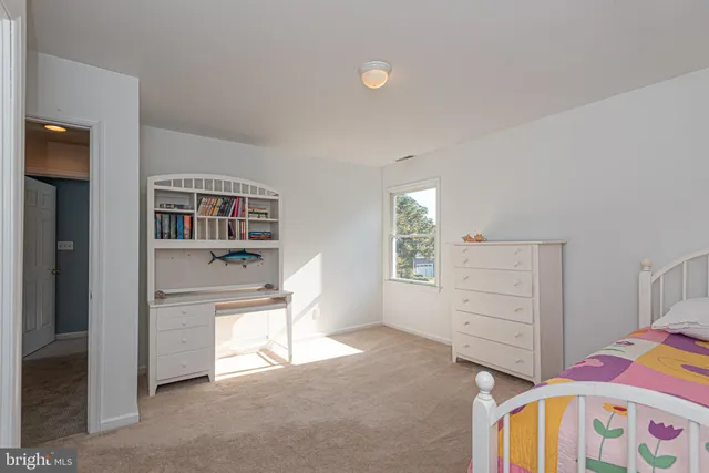 a bedroom with furniture and a window