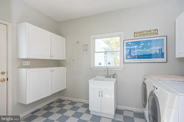 a utility room with a sink a washer and dryer