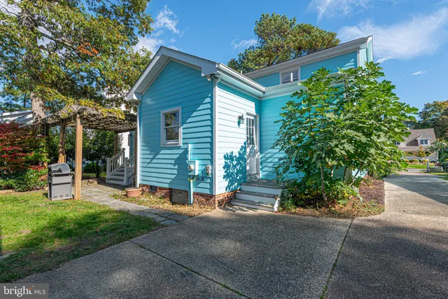 a view of a house with a yard and sitting area