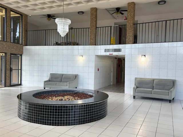 a living room with furniture a rug and a fireplace
