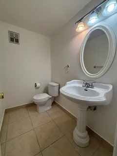 a bathroom with a sink a toilet and a mirror