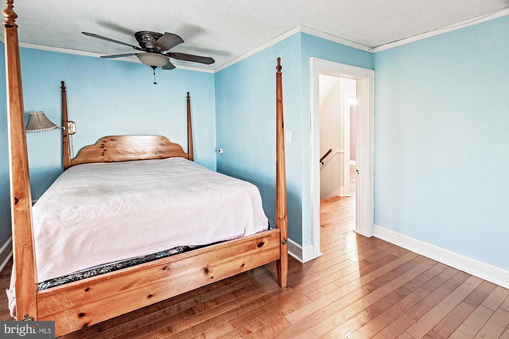 284 Morrison Avenue Salem, NJ 08079 - Photo 11 of 34 a bedroom with a bed and a chandelier