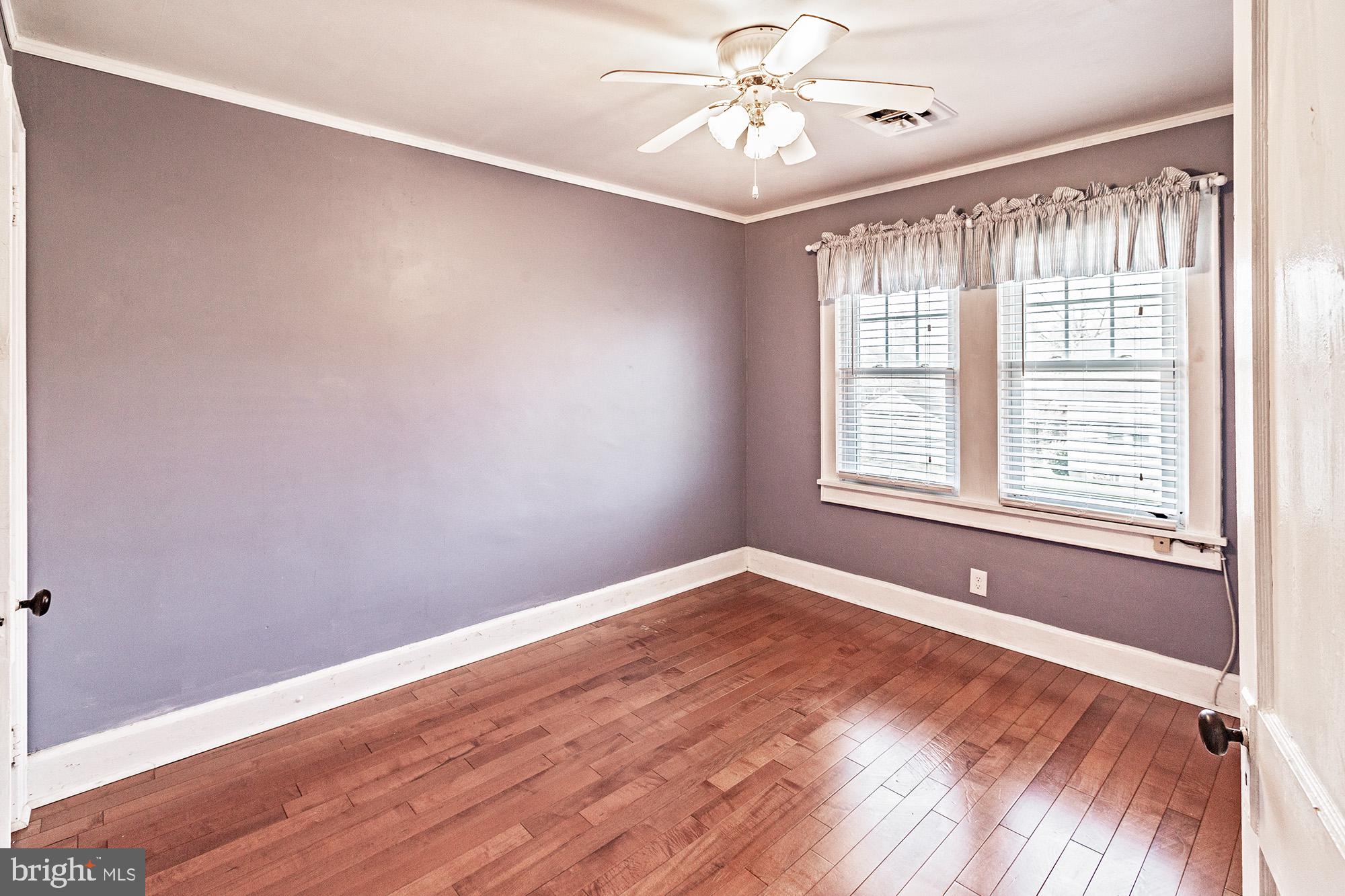 284 Morrison Avenue Salem, NJ 08079 - Photo 13 of 34 a view of an empty room with window and wooden floor