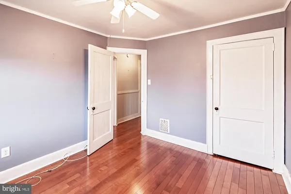 a view of empty room with wooden floor
