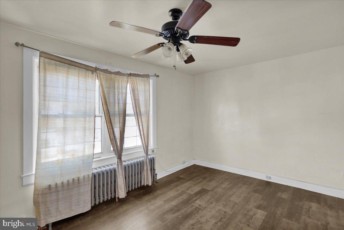 224 Hanley Place Reading, PA 19611 - Photo 14 of 19 an empty room with wooden floor fan and windows